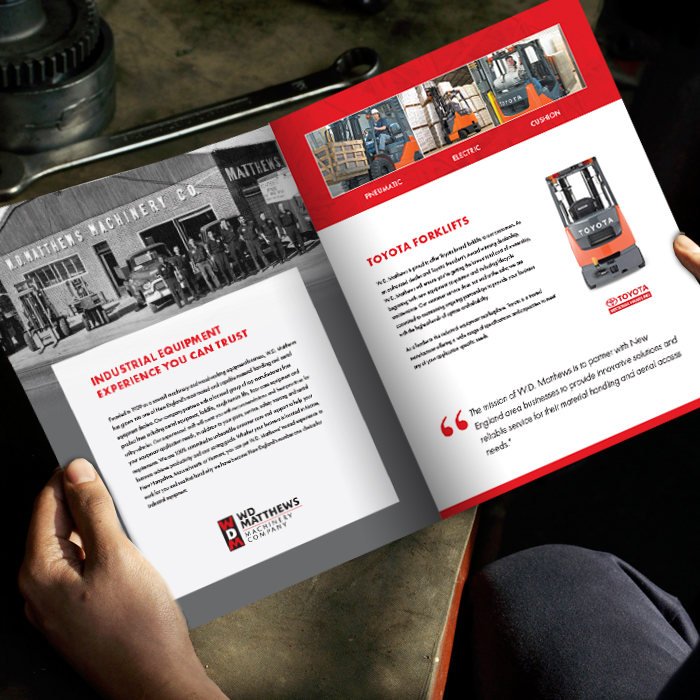 Person holding Forklift dealer corporate brochure